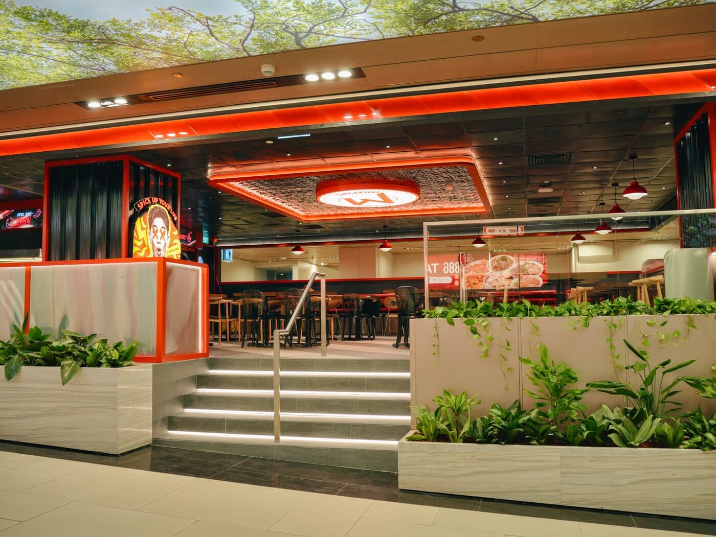 Entrance steps up to the Mala Mia unit at Changi Terminal 3, framed in orange neon